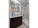 Bathroom vanity with vessel sink next to a tiled shower with a glass door at 12900 Vonn Rd # F101, Largo, FL 33774