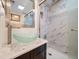 Bathroom featuring granite countertop, glass bowl sink, updated tiling in shower, and chrome hardware at 12900 Vonn Rd # F101, Largo, FL 33774