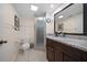 Modern bathroom with tiled floors, a granite countertop vanity, and walk-in shower at 12900 Vonn Rd # F101, Largo, FL 33774