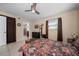 Well-lit bedroom boasts tiled floors, a ceiling fan, and convenient access to the ensuite bathroom at 12900 Vonn Rd # F101, Largo, FL 33774