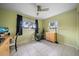 Bedroom with a ceiling fan, tile floors, and lots of natural light at 12900 Vonn Rd # F101, Largo, FL 33774