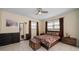 Serene bedroom featuring a ceiling fan, neutral paint, and tile floors for easy maintenance at 12900 Vonn Rd # F101, Largo, FL 33774