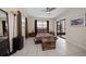 Comfortable bedroom with tile floors, fan, and natural light, plus direct access to outdoor lanai at 12900 Vonn Rd # F101, Largo, FL 33774