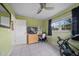 Bedroom featuring tile floors, natural light, a ceiling fan, and light green painted walls at 12900 Vonn Rd # F101, Largo, FL 33774