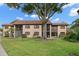 Exterior view of building featuring balconies and lawn at 12900 Vonn Rd # F101, Largo, FL 33774