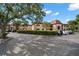 Exterior view of building featuring mature shade trees and parking at 12900 Vonn Rd # F101, Largo, FL 33774