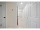 Hallway with a view of the bathroom shower with updated shower door and white interior doors at 12900 Vonn Rd # F101, Largo, FL 33774