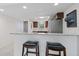 Stylish kitchen with granite counters, breakfast bar, and stainless steel appliances with easy access to the entry door at 12900 Vonn Rd # F101, Largo, FL 33774