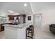 Bright kitchen boasting granite countertops, stainless steel appliances, tile floors, and a breakfast bar at 12900 Vonn Rd # F101, Largo, FL 33774