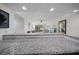 An open concept floor plan allows for the granite counter to overlook the living and dining areas at 12900 Vonn Rd # F101, Largo, FL 33774