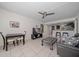 Open-concept living area featuring tile floors, neutral walls, and a ceiling fan for added comfort at 12900 Vonn Rd # F101, Largo, FL 33774