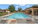 Large community pool featuring lounge chairs with a nearby covered structure at 12900 Vonn Rd # F101, Largo, FL 33774
