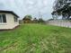 Large fenced backyard with a grass lawn at 12907 College Hill Dr, Hudson, FL 34667