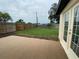 The backyard features a small patio area and mature green grass at 12907 College Hill Dr, Hudson, FL 34667