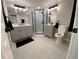 Elegant bathroom featuring double vanities, modern lighting, and a glass-enclosed shower at 12907 College Hill Dr, Hudson, FL 34667