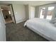 Comfortable bedroom with carpet, closet, and backyard access through white French doors at 12907 College Hill Dr, Hudson, FL 34667