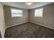 Cozy bedroom with plush carpeting, neutral paint, and bright windows offering natural light at 12907 College Hill Dr, Hudson, FL 34667