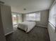 Bright bedroom featuring a double door entry to the backyard and neutral decor at 12907 College Hill Dr, Hudson, FL 34667