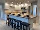 Modern kitchen features white cabinetry, stainless steel appliances, butcher block counters and island with seating at 12907 College Hill Dr, Hudson, FL 34667
