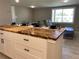 Open-concept living featuring kitchen island with butcher block countertops and open sight lines to other living spaces at 12907 College Hill Dr, Hudson, FL 34667