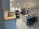 Well-lit kitchen featuring white shaker cabinets, modern appliances, butcher block countertops, and an island with seating at 12907 College Hill Dr, Hudson, FL 34667