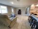 Relaxing living space with tile flooring, a cozy fireplace, and a clear view of the adjacent kitchen at 12907 College Hill Dr, Hudson, FL 34667