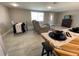 Inviting living and dining area with stylish tile flooring, contemporary furniture, and natural light at 12907 College Hill Dr, Hudson, FL 34667