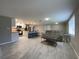 Spacious open-concept living room with modern tile flooring seamlessly connected to a well-equipped kitchen at 12907 College Hill Dr, Hudson, FL 34667