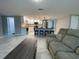 Open-concept layout connecting the living room and kitchen, featuring stylish bar stool seating at 12907 College Hill Dr, Hudson, FL 34667