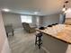 Inviting living space featuring an island with seating flowing into the living room at 12907 College Hill Dr, Hudson, FL 34667