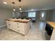 Bright living space featuring an open floor plan with a kitchen island and comfortable seating at 12907 College Hill Dr, Hudson, FL 34667