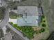 Overhead aerial view showcasing property lines, green roof, surrounding landscape, and neighborhood layout at 13209 Palmilla Cir, Dade City, FL 33525