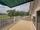 A covered balcony overlooks a lush green golf course at 13209 Palmilla Cir, Dade City, FL 33525