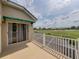 Enjoy golf course views from the private balcony with white railings and a green awning at 13209 Palmilla Cir, Dade City, FL 33525