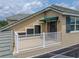 Balcony with awning and golf course view shows the building's beige stucco and neutral roof at 13209 Palmilla Cir, Dade City, FL 33525