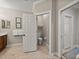 View of a bathroom with neutral walls and floor; an open door reveals a toilet at 13209 Palmilla Cir, Dade City, FL 33525
