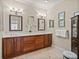 Bathroom boasts a spacious double vanity with wood cabinets, mirrors, and overhead lighting at 13209 Palmilla Cir, Dade City, FL 33525