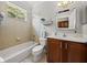 Bright bathroom features vanity, tub, shower combination with natural lighting at 13209 Palmilla Cir, Dade City, FL 33525