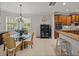 Dining area featuring a glass table, wicker chairs, and natural lighting at 13209 Palmilla Cir, Dade City, FL 33525
