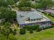 Expansive home featuring a screened pool, lush landscaping, and a beautiful tile roof at 13209 Palmilla Cir, Dade City, FL 33525