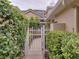 Charming front gate with lush greenery and manicured shrubs at 13209 Palmilla Cir, Dade City, FL 33525