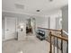 Carpeted upstairs hallway with staircase, lighting, and built-in shelving at 13209 Palmilla Cir, Dade City, FL 33525