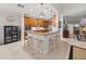 Spacious kitchen featuring wood cabinetry, stainless steel appliances, granite countertops, and bar seating at 13209 Palmilla Cir, Dade City, FL 33525