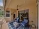 Screened patio featuring cozy seating and convenient access to the outdoors at 13209 Palmilla Cir, Dade City, FL 33525
