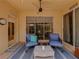 Covered patio features comfortable seating, fan, and easy access to the interior at 13209 Palmilla Cir, Dade City, FL 33525