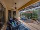 Covered lanai furnished with seating, ceiling fan, and views of the green garden at 13209 Palmilla Cir, Dade City, FL 33525