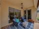 Outdoor lanai features comfortable seating and views of the serene landscape at 13209 Palmilla Cir, Dade City, FL 33525