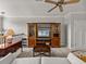 Living room featuring a ceiling fan, entertainment center, and stylish furnishings at 13209 Palmilla Cir, Dade City, FL 33525