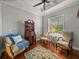 Cozy living room with hardwood floors, a ceiling fan, and plenty of natural light from the large window at 13209 Palmilla Cir, Dade City, FL 33525