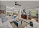 Bright living area boasts a white sectional, ceiling fan, and seamless flow to dining and other spaces at 13209 Palmilla Cir, Dade City, FL 33525